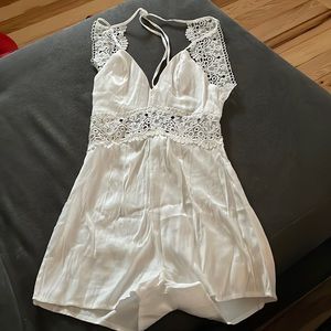 White silk romper with a lace back